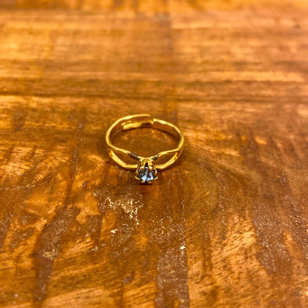 Gold ring with light blue gem